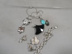 A quantity of silver jewellery, including a bracelet, pendants, brooches etc