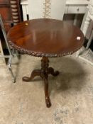 A reproduction carved mahogany occasional table with birdcage mechanism Dia. 60 cm