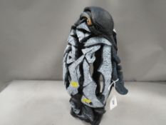 An Edge sculpture by Matt Buckley of a penguin with a chick