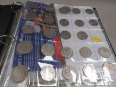 An album of coins to include US State Quarters, 50 pences, Euros etc