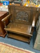 A carved oak monks bench W 91 cm
