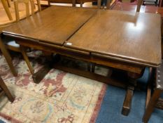 A large 20th century oak draw leaf dining table with one additional leaf