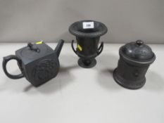 A Wedgwood style black Basalt teapot with Oriental style decoration to panels and dog finial -