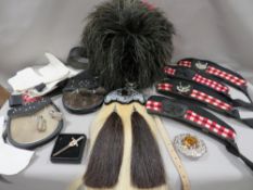 A feather bonnet together with a tray containing a new horsehair sporran, sealskin sporran, pair