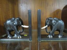 A pair of carved wooden bookends