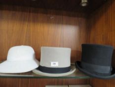 A 100% hand-made black silk lined top hat size L together with a used grey example and a pithed