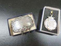 A hallmarked silver St Johns ambulance fob medal in original box and silver Sherry wine label
