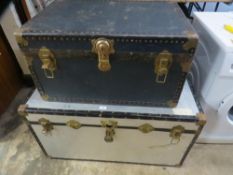 An aluminium travel trunk and a smaller travel trunk