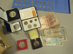 A box of old coins and banknotes