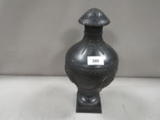A Wedgwood black Basalt lidded urn - lid damaged with typical classical vignettes and musical