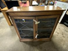 A late 19th century oak glazed two door bookcase W 107 cm