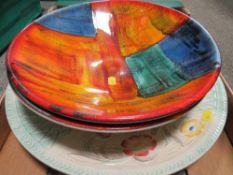 A large Poole dish together with a similar damaged example and a charger (3)