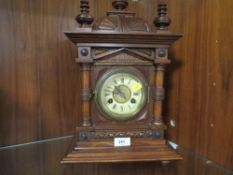 A carved wooden mantle clock