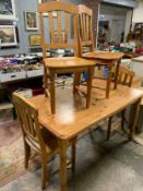A honey pine kitchen table and four chairs