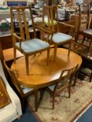 A mid century teak extending dining table and six chairs