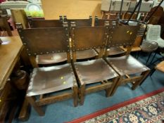 A set of six 20th century oak carved and leather dining chairs by Thomas Clarkson and Sons of