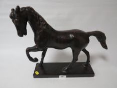 A modern bronze effect model of a horse