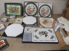 A tray of various placemats together with a box of napkins etc