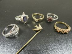 A collection of 5 assorted silver and other dress rings together with a stick pin (6)