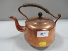 An Arts & Crafts copper kettle impressed to base T & Co