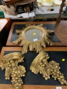 A small circular gilt mirror together with a pair of gilt fruit wall brackets. (3)