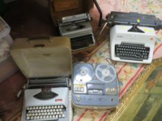 A selection of vintage typewriters, reel to reel player etc