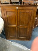 A Georgian oak corner cupboard