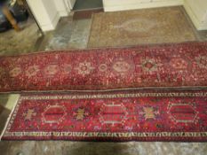Three rugs to include two runners - 390 cm x 93 cm, 298 cm, x 66 cm and a silk rug 125 x 200 cm (3)