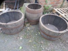 Three oak half barrel garden planters
