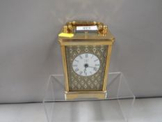 A Halcyon Days enamelled decorated carriage clock with key