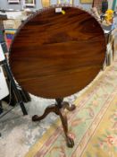A reproduction mahogany Chippendale style pedestal table with a birdcage mechanism