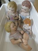 Four vintage porcelain baby figures