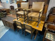 An oak refectory style table together with six oak studded dining chairs