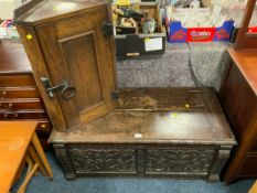 A carved oak blanket box together with a small oak corner cupboard. (2)