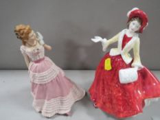 A Royal Doulton figurine Christmas Day 1999 together with a Wedgwood figurine