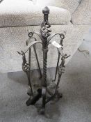 A wrought iron companion set