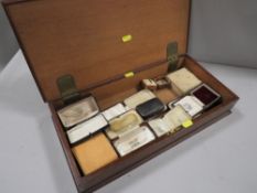 A wooden box of antique jewellery presentation boxes