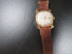 A 1950's Oris gentleman's wristwatch, in square case with fancy lugs, champagne dial, with baton