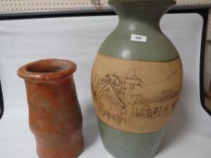 A large studio vase decorated with a street scene signed to base Therese Jones & Alan Tucker