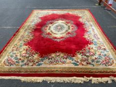 A large Chinese woollen rug 430 x 305 cm