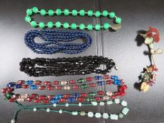 A quantity of antique bead necklaces, including jade types