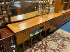A mid century ‘Butilux’ teak dressing table, stool and four drawer chest (2)