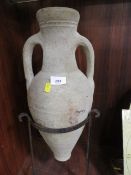 An Amphora jug in cast metal display stand
