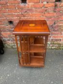 A reproduction mahogany inlaid revolving bookcase