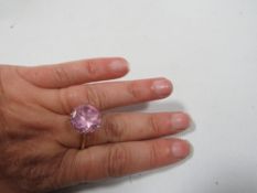 A 9ct gold ring set with a large pink stone, approx weight 7.1 g