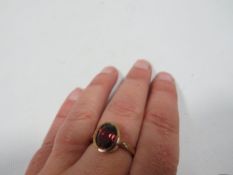 A garnet dress ring in over rub setting stamped 9k approx. weight 4g
