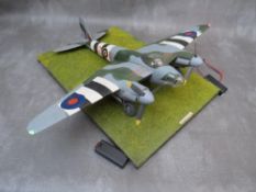 A model of a DeHavilland Mosquito Mk4 on display stand, with working propellors and wing lights,