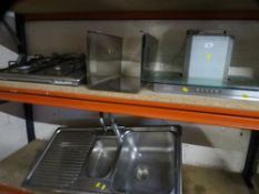 A stainless steel gas hob / extraction unit together with a sink