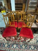 A set of four Edwardian mahogany carved dining chairs