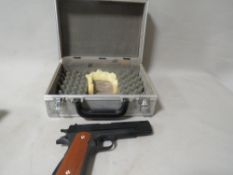 An unmarked air pistol in hard shell case